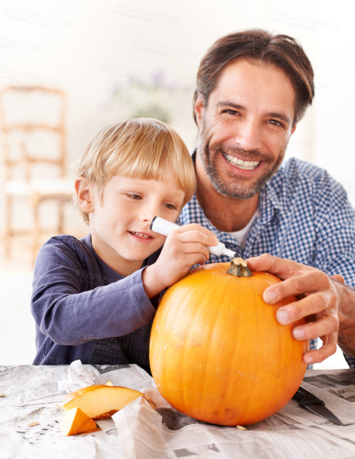 Buy stock photo Portrait of a father and son marking a pumpkin for halloween