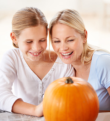 Buy stock photo Child, mother and smile with pumpkin to celebrate halloween party together at home. Happy young girl, mom and family carving orange vegetable for holiday lantern, decoration and fun creative craft 