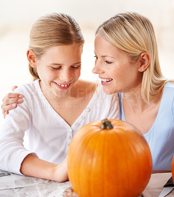 Buy stock photo Happy, mother and child with pumpkin to celebrate halloween, party and fun together at home. Young girl, mom and family carving orange vegetable for holiday lantern, decoration or creativity of craft