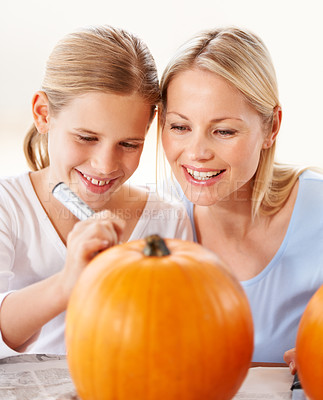Buy stock photo Child, mother and smile for drawing on pumpkin, craft and celebrate halloween party at home. Happy girl kid, mom or family writing with pen marker on vegetable, holiday lantern or creative decoration