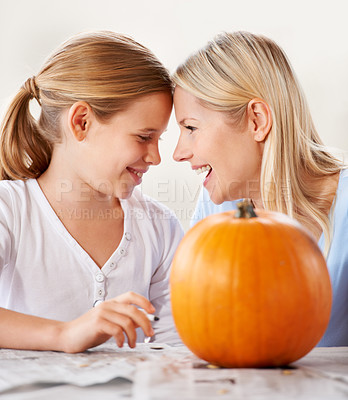 Buy stock photo Mother, daughter or happy with pumpkin for halloween, celebration or decoration in kitchen of apartment home. Family, face or smile and vegetable for preparation, holiday or creative event in house
