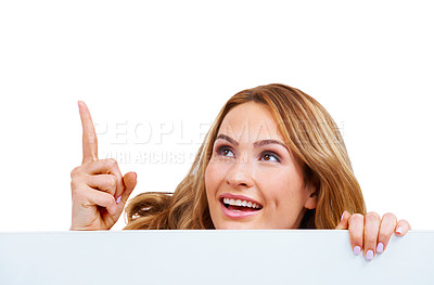Buy stock photo Woman, poster and pointing at information or peeking in studio for communication, announcement or white background. Female person, billboard placard as mockup for promotion, advertising or signage