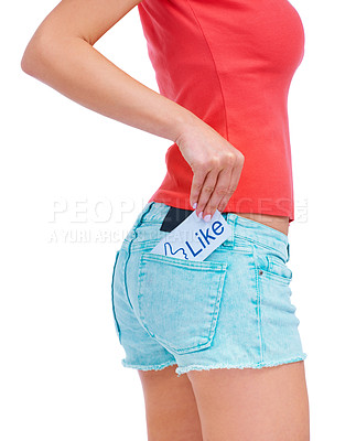 Buy stock photo Cropped image of a young woman with a card saying "like" tucked into her denim shorts