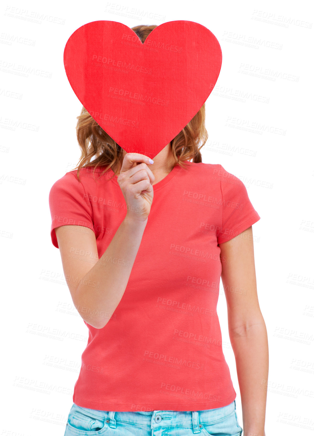 Buy stock photo A young woman holding a heart-shaped placard over her face while isolated on white