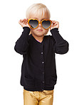 A cute little blonde girl putting on heart-shaped sunglasses