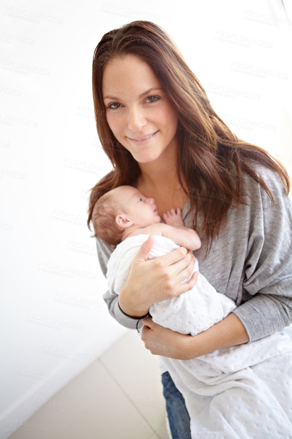 Buy stock photo Mother, portrait and holding newborn in family home with love, happiness or care with smile. Young mom, infant child or baby with happy bonding, pride or hug together with blanket in morning at house