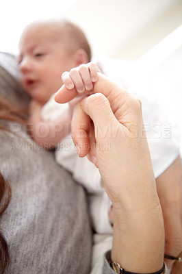 Buy stock photo Baby, mother and holding finger in closeup with love, care and bonding in morning sunshine at family home. Mama, infant child and together with hands, touch and connection with development in house