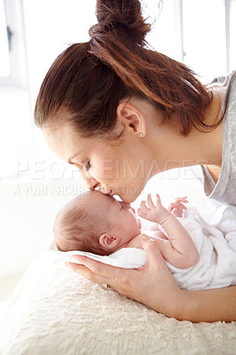 Buy stock photo Closeup shot of a mother tenderly kissing her newborn baby