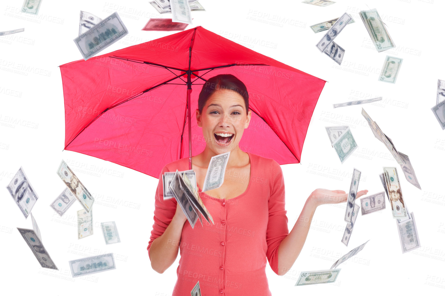 Buy stock photo Pretty young woman under a red umbrella with money showering down