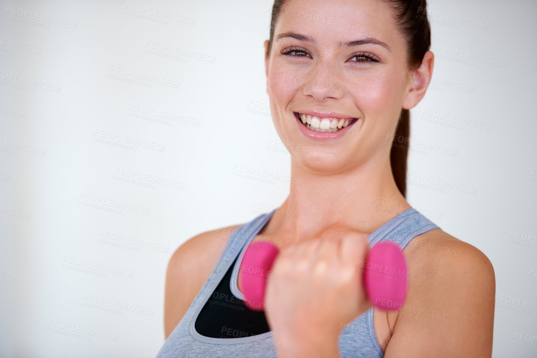 Buy stock photo Woman, health and portrait with dumbbells in studio for training wellness, fitness and weight loss with exercise. Young person, happy and face with hand weights for tone muscle by white background