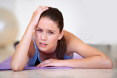 Buy stock photo Portrait of a young woman lying in the gym and looking exhausted