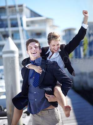 Buy stock photo Celebration, piggyback and corporate couple at harbor excited for success, startup or travel freedom. Business people, victory and man with woman before traveling in Amsterdam, winning and hand sign