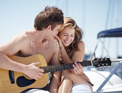 Buy stock photo Guitar, yacht and couple on romantic date feeling happy, excited and with love together at the beach or sea. Luxury, music and man singing for a woman while bonding on summer vacation or holiday