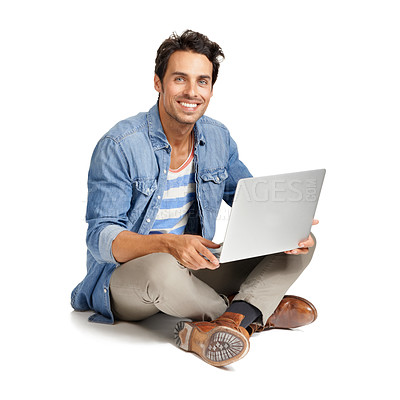 Buy stock photo A handsome young man working on his laptop against a while background