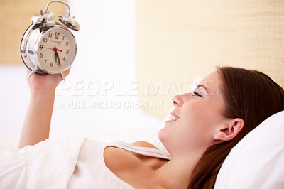Buy stock photo Alarm, clock and happy woman in a bed with morning, alert or bell ring for start of day or routine in her home. Time, wake up and female person smile in a bedroom after peaceful sleep, nap or resting