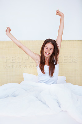 Buy stock photo A gorgeous young woman stretching out after a night's sleep