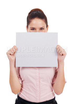 Buy stock photo Studio shot of a young women holding up a small blank placard in front of her face isolated on white