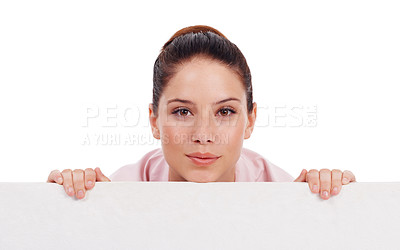 Buy stock photo Portrait, mockup poster and woman peeking over in studio isolated on a white background. Face, board and female person with copy space, advertising and marketing, commercial promotion and branding.