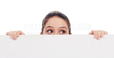 Buy stock photo Eyes, mockup and poster with a woman in studio isolated on a white background holding blank space while thinking. Idea, peek and placard with a young female model advertising on an empty billboard