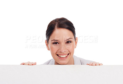 Buy stock photo Portrait, mockup board and woman peeking over in studio isolated on a white background. Face, poster and happy female person with copy space, advertising and marketing, promotion and commercial.