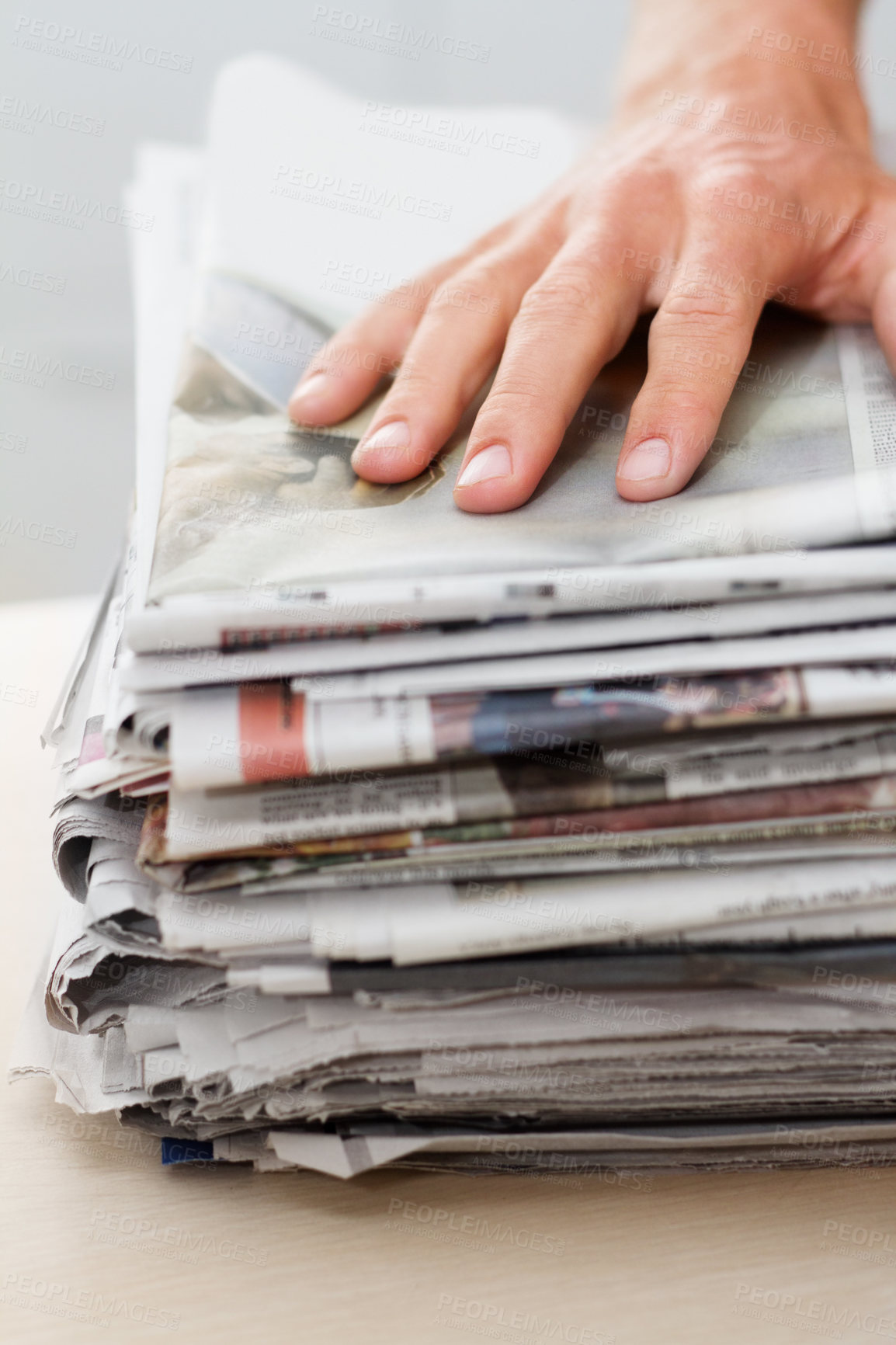 Buy stock photo Newspaper, sustainability and hand of man on stack for recycling, environment and resources. Eco friendly, waste and news with closeup of person and paper for responsibility, garbage and conservation