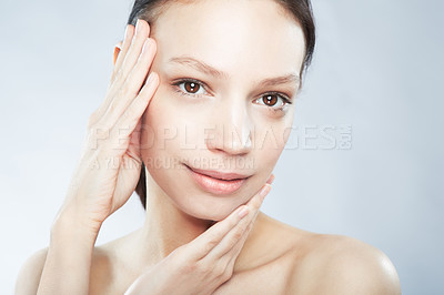 Buy stock photo Head and shoulder portrait of a beautiful young woman in the nude posing with and hands on her face