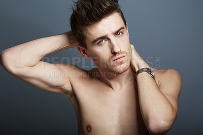 Buy stock photo Cropped shot of a handsome young man posing in the studio