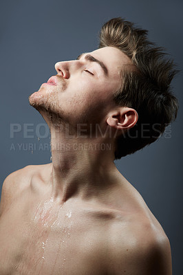 Buy stock photo Cropped shot of a handsome young man posing in the studio