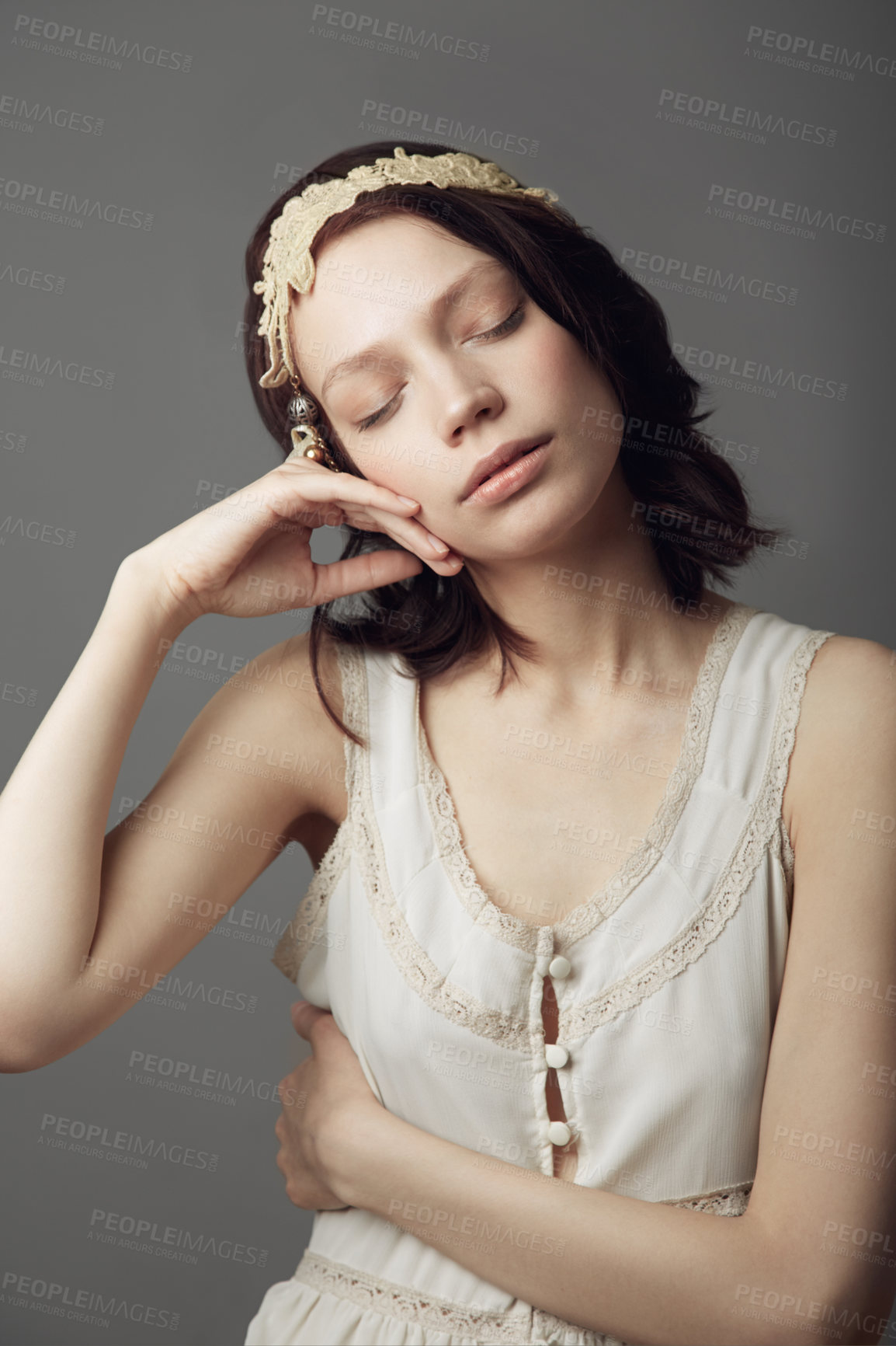 Buy stock photo A beautiful young woman wearing vintage clothing and posing with eyes closed and hand on her cheek