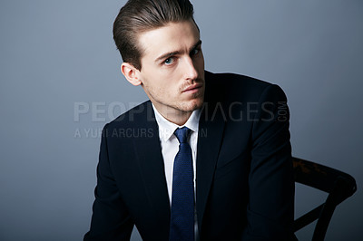 Buy stock photo Cropped shot of a handsome and fashionable young man posing in the studio