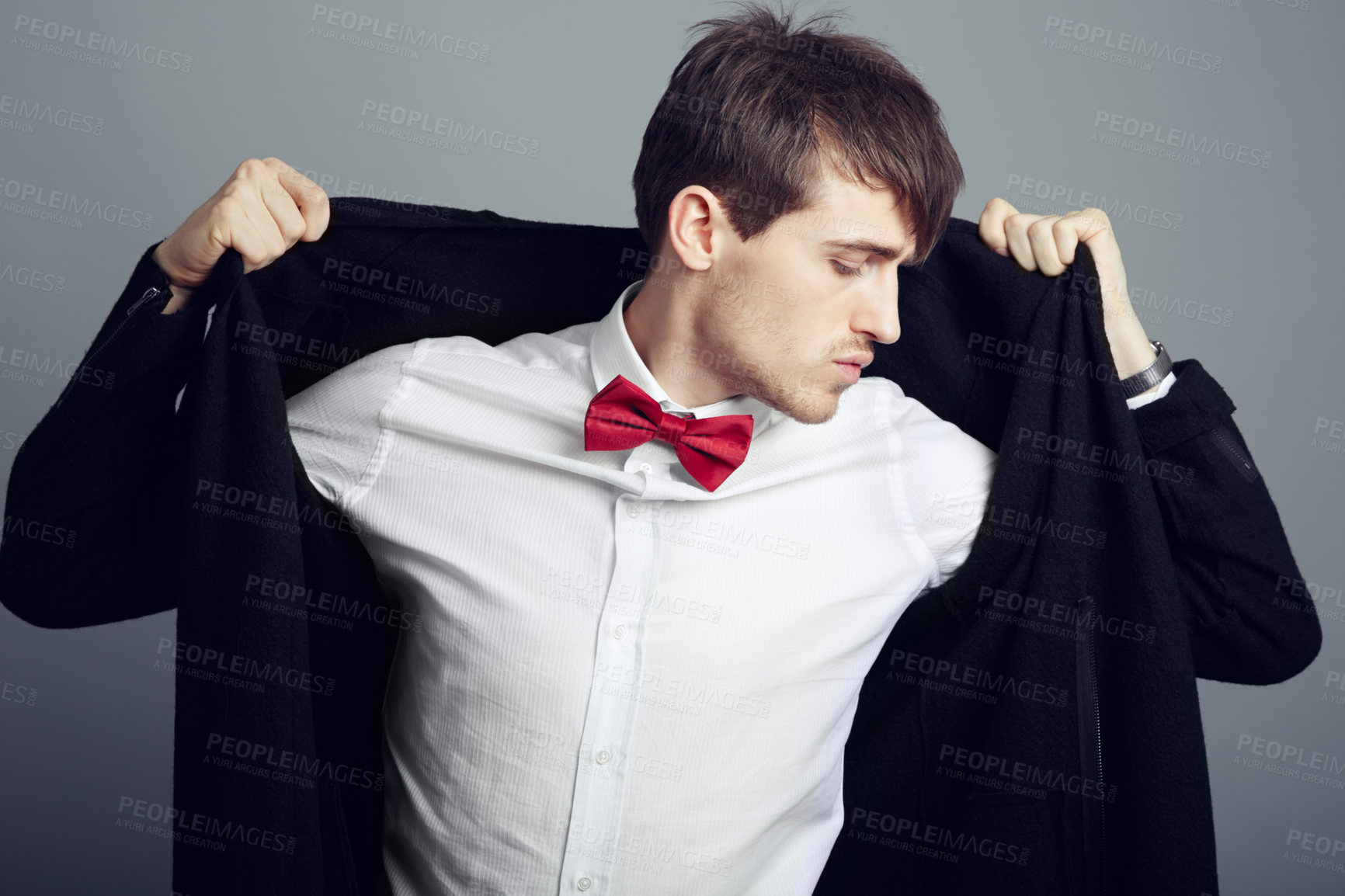 Buy stock photo Cropped shot of a handsome and fashionable young man posing in the studio