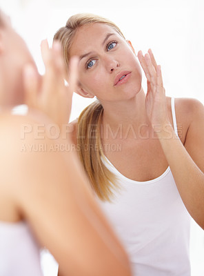 Buy stock photo Cropped shot of a beautiful woman touching her face