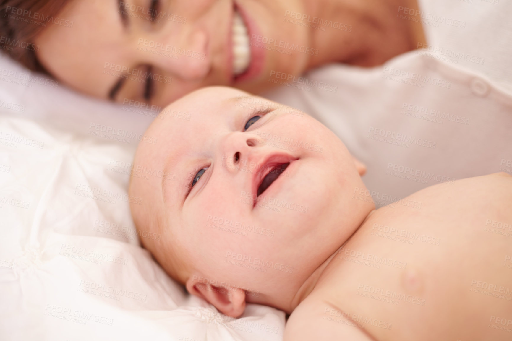 Buy stock photo Mother, baby and happiness or love, care and relaxing on bed, bonding and joy in parenthood. Mom, newborn and peace or calm at home, positive and happy for child development, smile and rest together