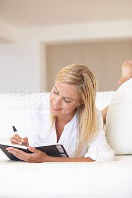 Buy stock photo Writing, notebook and planning with woman on sofa for goals, diary and schedule. Calendar, relax and list with female person and journal in living room of home for self care, reflection and idea