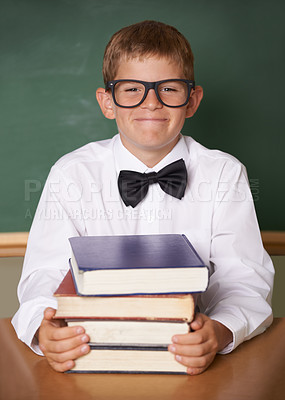 Buy stock photo Boy child, happy and portrait with books, classroom and learning for exam, assessment and studying for knowledge. Student kid, notebook and smile for education, development and glasses at table