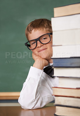 Buy stock photo Child, school portrait and stack of books for education, language learning and knowledge in classroom. Happy face of kid, boy or student in glasses with textbook, literature and library resources 