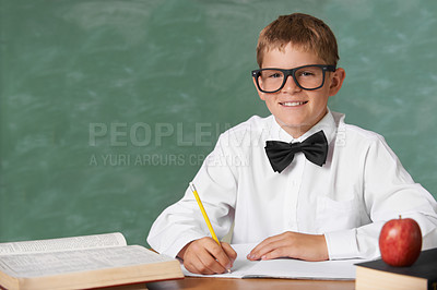 Buy stock photo Young boy, portrait and writing at school for learning, education or knowledge with green chalk board. Face of male person, smart child or teenager smile with books for academic literature in class
