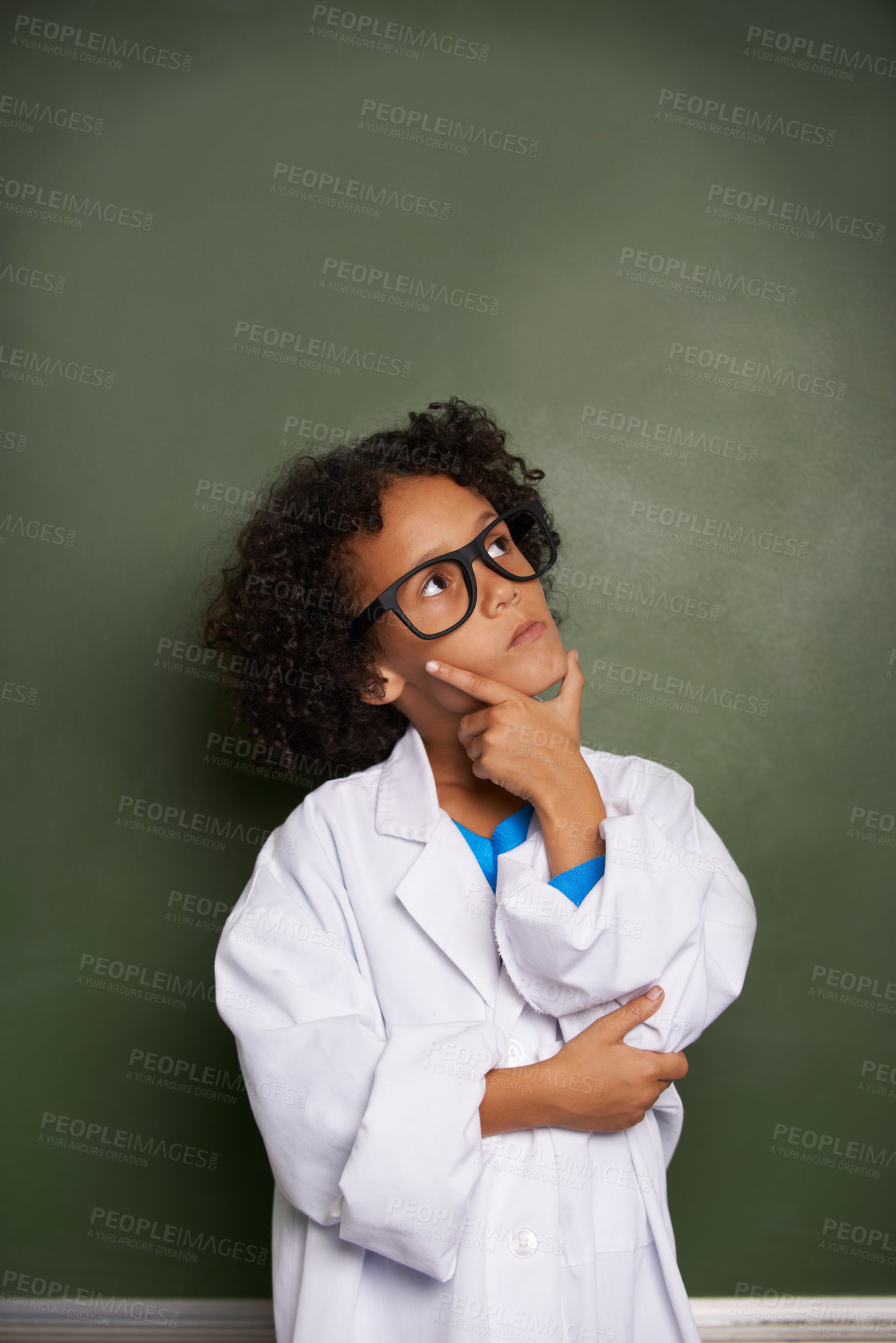 Buy stock photo An ethnic boy wearing glasses and a lab coat looking contemplative - copyspace