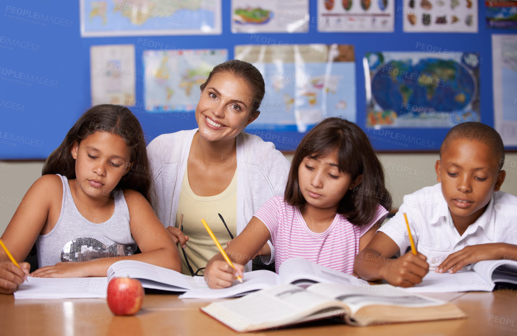 Buy stock photo Teacher, portrait and school kids in classroom, writing or learning together for development, studying or knowledge. Woman, children and notebook with support, teaching and education with smile