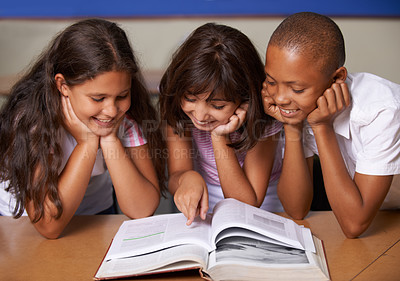 Buy stock photo School kids, reading and happy in classroom with book, pointing and thinking with learning, diversity or info. Children, development and education with friends, students and smile for assessment