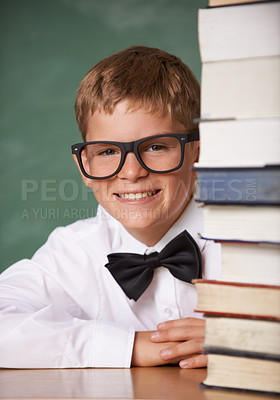 Buy stock photo Boy kid, smile and portrait with books, classroom and learning for exam, assessment and studying for knowledge. Student child, notebook and happy for education, development and glasses by chalkboard