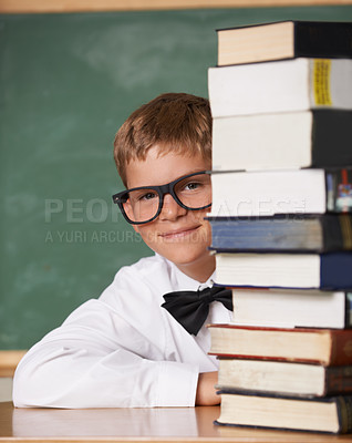 Buy stock photo Boy kid, happy and portrait with books, classroom and learning for exam, assessment and studying for knowledge. Student child, notebook and smile for education, development and glasses by chalkboard