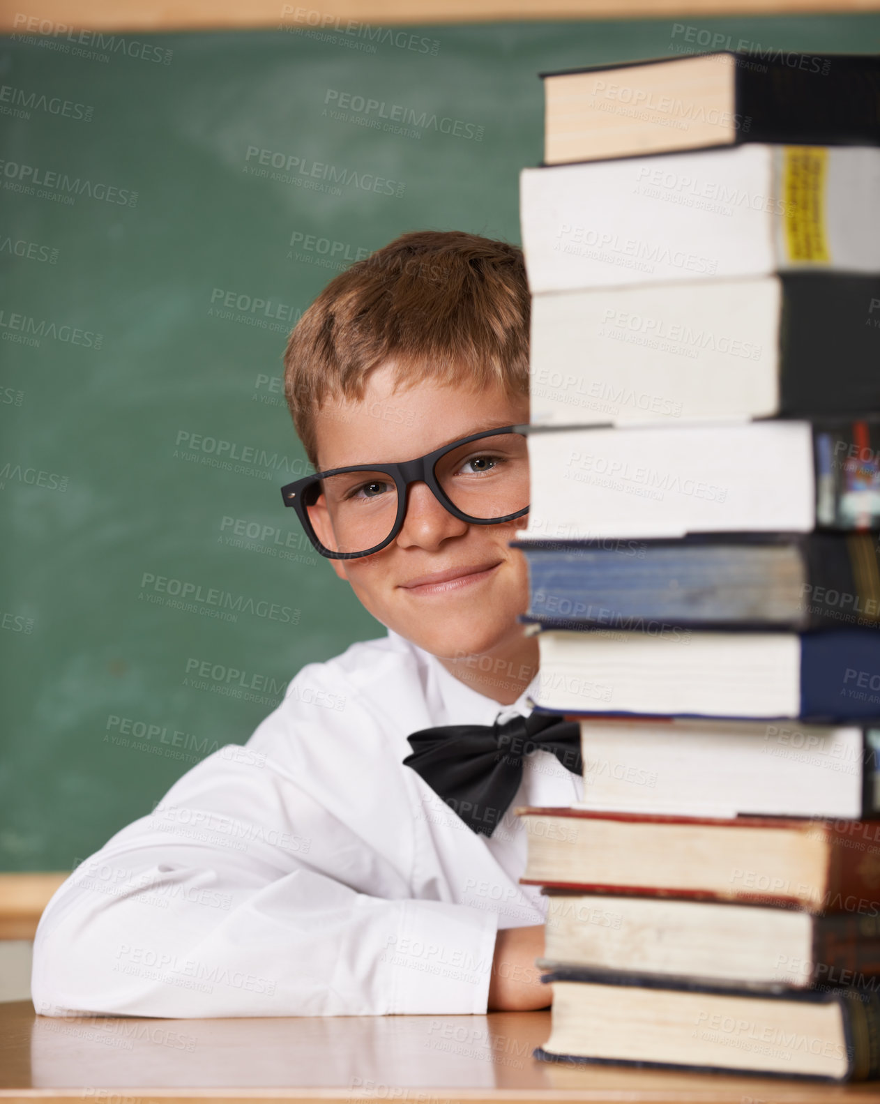 Buy stock photo Boy kid, happy and portrait with books, classroom and learning for exam, assessment and studying for knowledge. Student child, notebook and smile for education, development and glasses by chalkboard