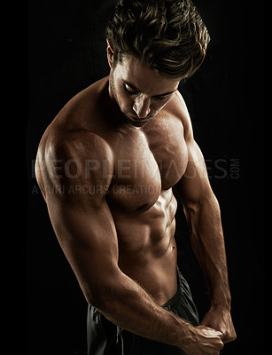 Buy stock photo Muscular young man showing off his defined body
