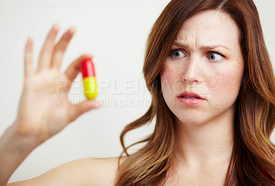 Buy stock photo A worried young woman looking at an oversized tablet