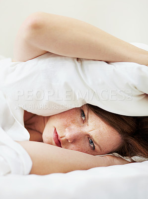 Buy stock photo Insomnia, angry and woman with pillow on ears to block noise, loud sound and sleep fail on bed in bedroom. Fatigue, person and covering head with cushion for problem, tired and frustrated at night.