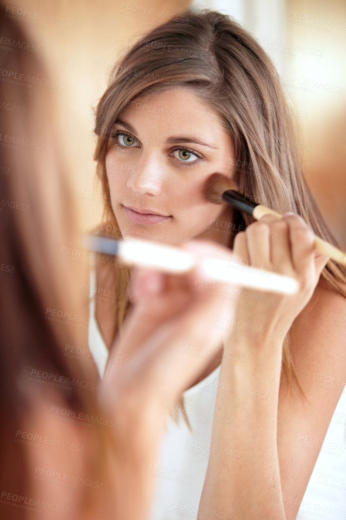 Buy stock photo Mirror, makeup and brush on face of woman in bathroom for morning skincare routine, dermatology and beauty. Facial, reflection and girl with tools for foundation, cosmetics and skin care glow in home