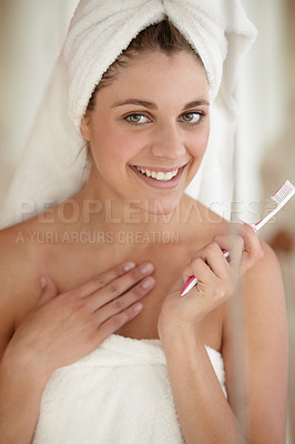 Buy stock photo An attractive young woman brushing her teeth
