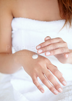 Buy stock photo Cropped shot of a woman applying moisturizer to her hands