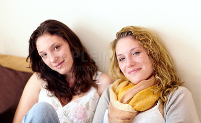 Buy stock photo Friends, women and relaxing on sofa, portrait and smiling at home for bonding in living room. People, face and social or happy on couch, trust and support or peace and solidarity in sisterhood